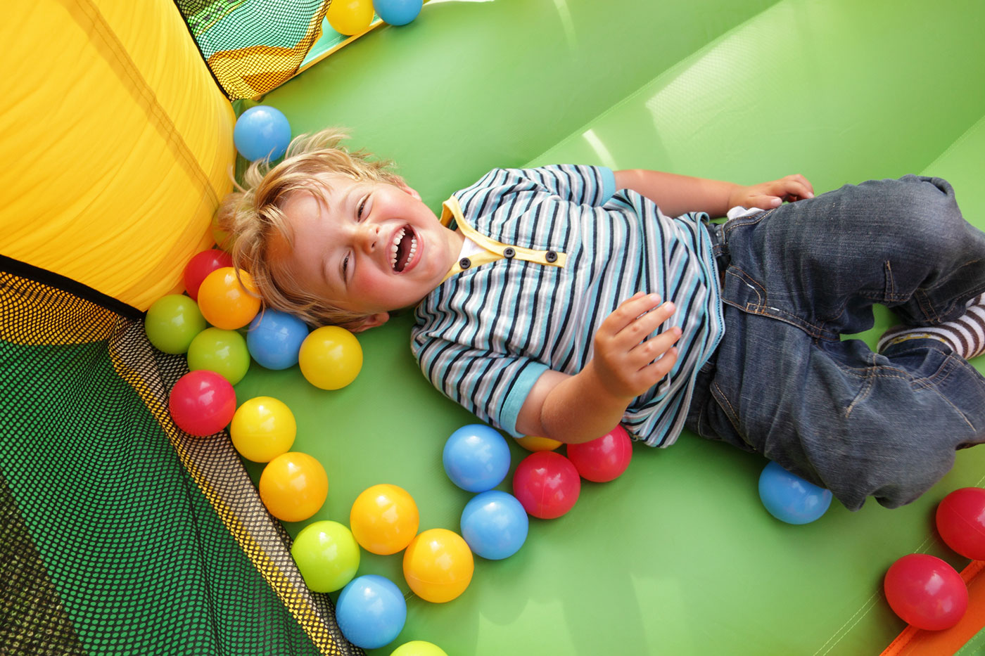 A child having fun playing in the ball pit